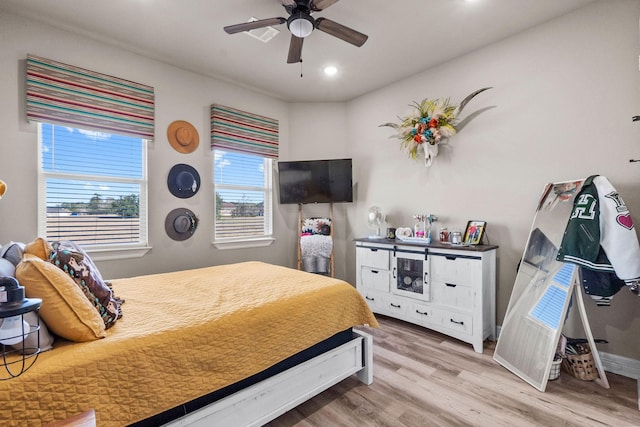 bedroom with hardwood / wood-style flooring and ceiling fan