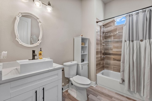 full bathroom with shower / bath combo with shower curtain, hardwood / wood-style floors, toilet, and vanity