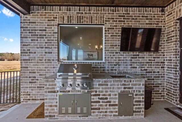 view of patio with sink and area for grilling