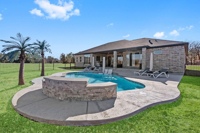 view of swimming pool featuring a lawn and a patio