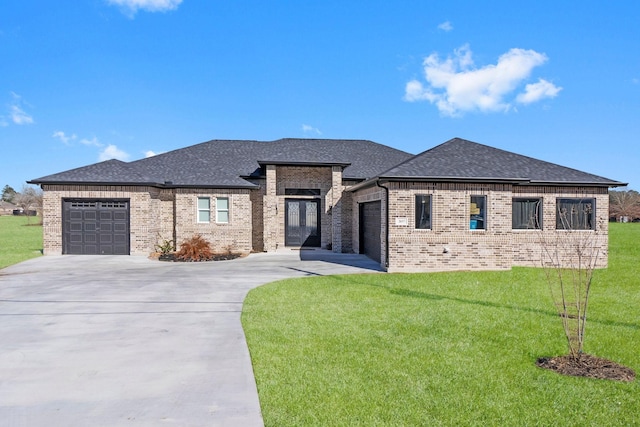 prairie-style home with a garage and a front lawn