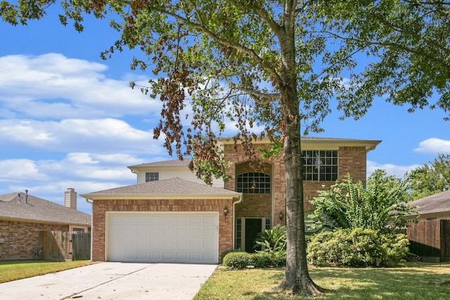 view of front of house with a front yard and a garage