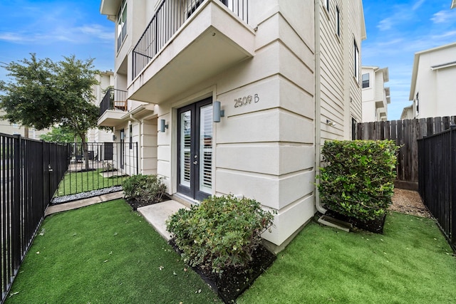 view of exterior entry with a lawn