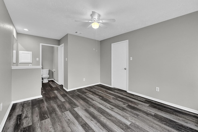 unfurnished room featuring ceiling fan, dark hardwood / wood-style floors, and a textured ceiling