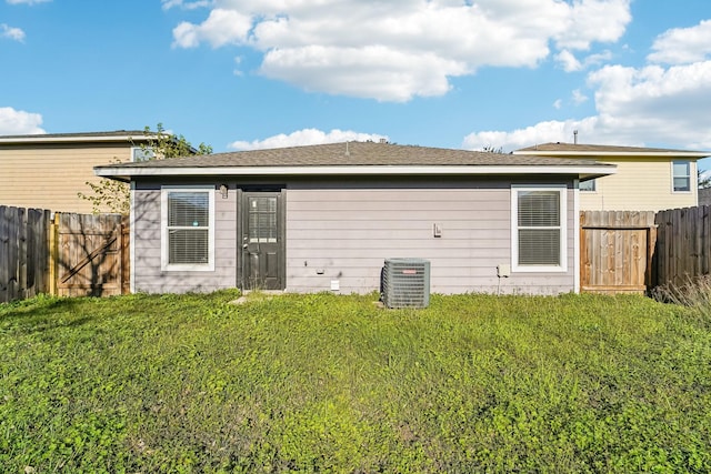 back of house with a lawn and cooling unit