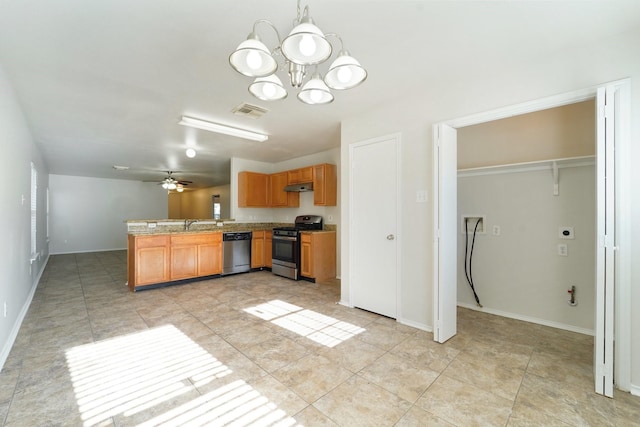 kitchen featuring ceiling fan with notable chandelier, appliances with stainless steel finishes, sink, hanging light fixtures, and kitchen peninsula