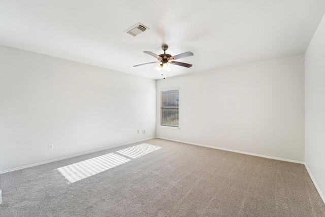 carpeted spare room featuring ceiling fan