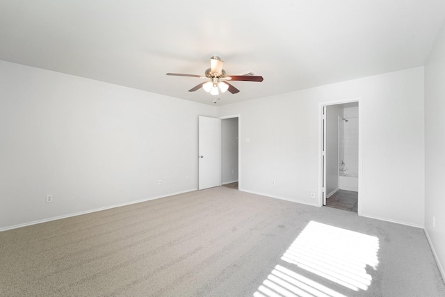 empty room featuring light colored carpet and ceiling fan