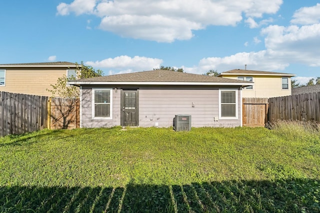 back of house with a lawn