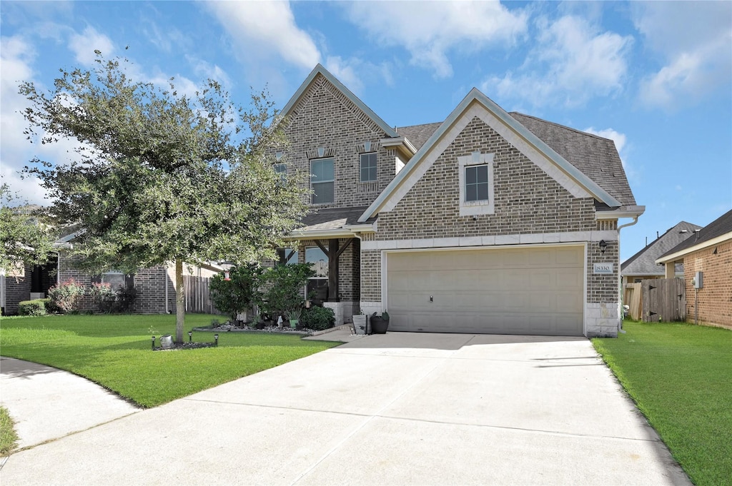 craftsman house with a garage and a front yard