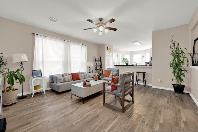 living room with hardwood / wood-style flooring, a healthy amount of sunlight, and ceiling fan