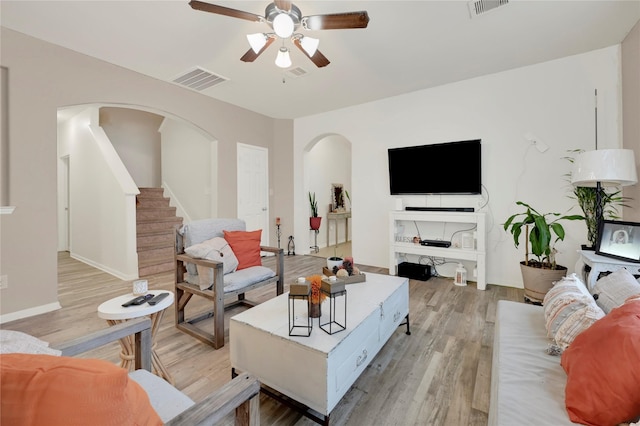 living room featuring light hardwood / wood-style flooring and ceiling fan