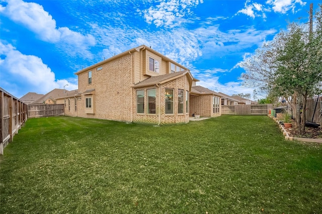 rear view of house with a yard