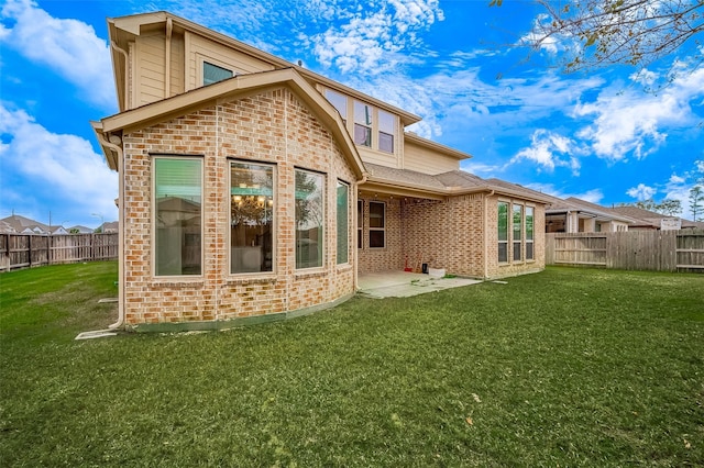 back of property with a lawn and a patio