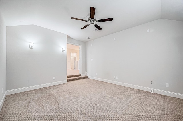 carpeted empty room with ceiling fan and lofted ceiling