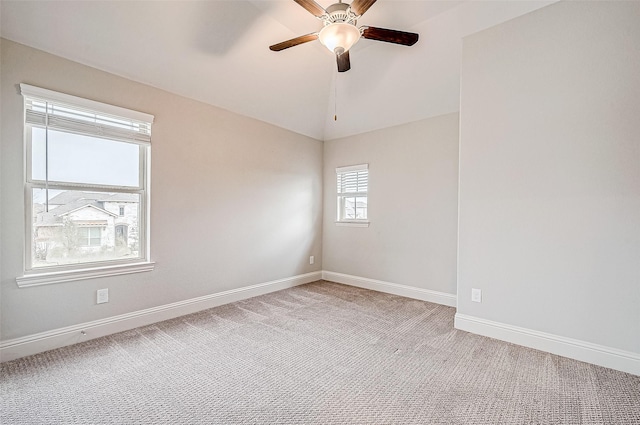 carpeted spare room with ceiling fan and lofted ceiling