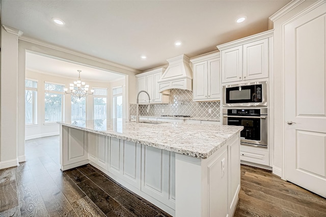 kitchen featuring crown molding, custom exhaust hood, sink, white cabinets, and stainless steel appliances