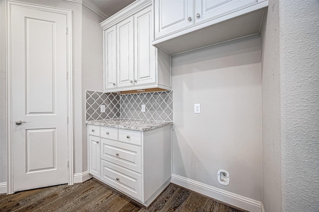 washroom with ornamental molding and dark hardwood / wood-style flooring