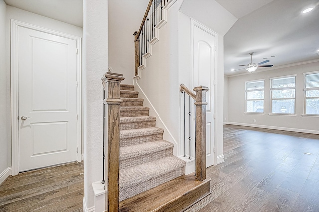 stairway with hardwood / wood-style flooring, crown molding, and ceiling fan