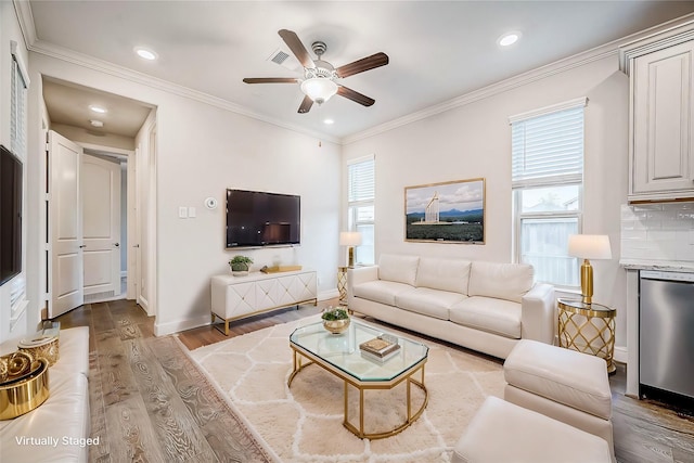 living room with crown molding, hardwood / wood-style floors, and ceiling fan