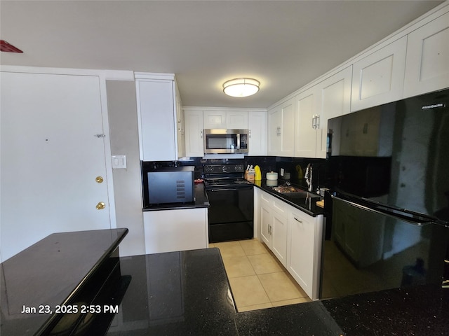 kitchen with sink, backsplash, white cabinets, light tile patterned flooring, and black appliances