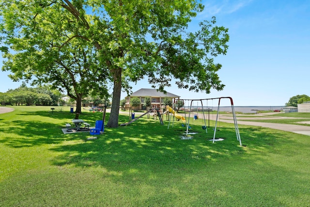 exterior space featuring a playground and a yard