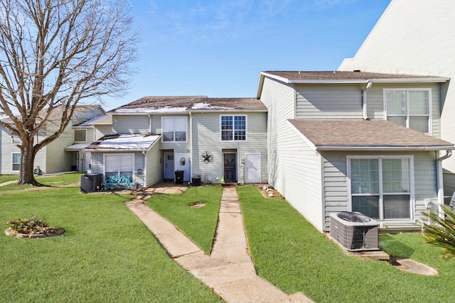 view of front of property featuring cooling unit and a front lawn