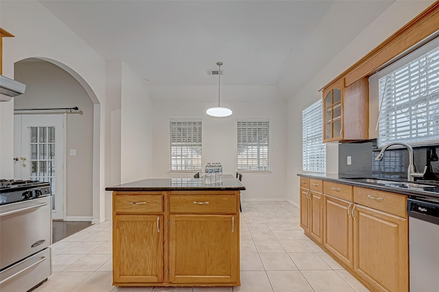 kitchen featuring sink, decorative light fixtures, light tile patterned floors, and stainless steel appliances