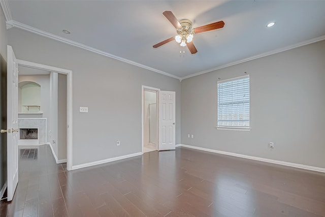 spare room with ceiling fan, dark hardwood / wood-style flooring, and ornamental molding