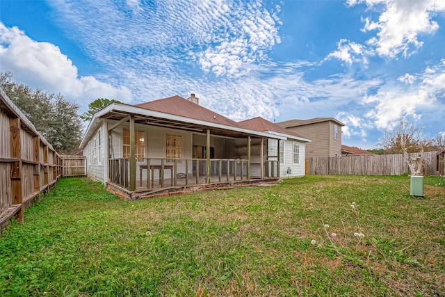 back of property featuring a yard