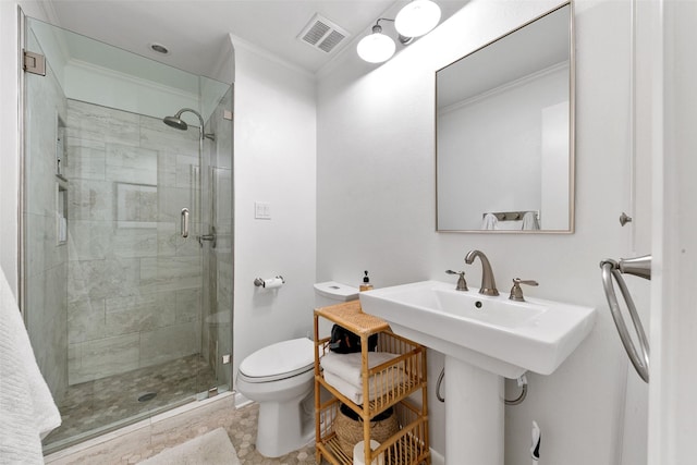 bathroom featuring toilet, ornamental molding, and a shower with door