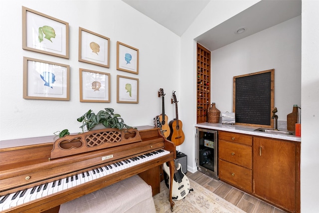 misc room with wet bar, beverage cooler, and lofted ceiling