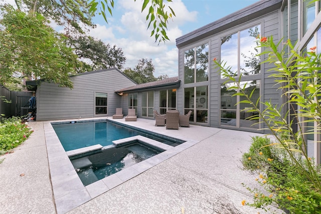 view of pool featuring an in ground hot tub and a patio area