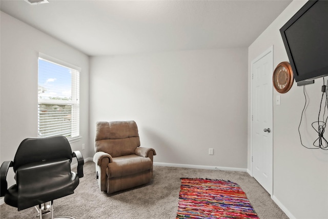 sitting room featuring light colored carpet