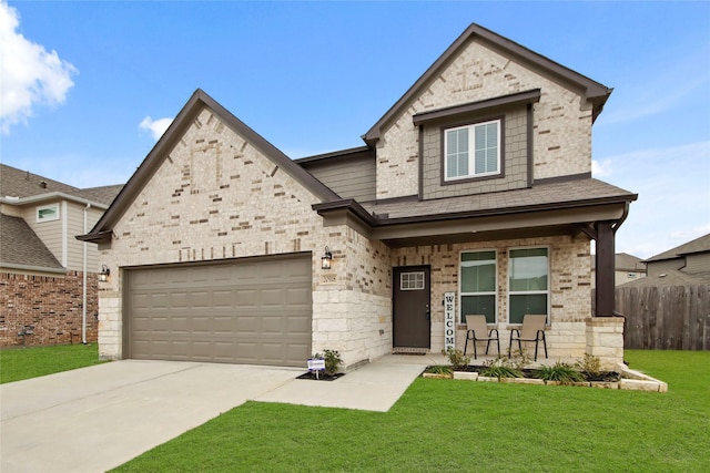 view of front of property with a garage, a front yard, and a porch