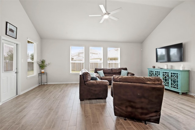 living room featuring ceiling fan, lofted ceiling, and light hardwood / wood-style floors