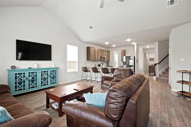 living room featuring lofted ceiling and ceiling fan