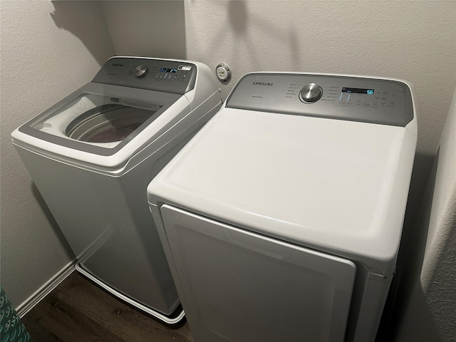 laundry room with wood-type flooring and washer and dryer