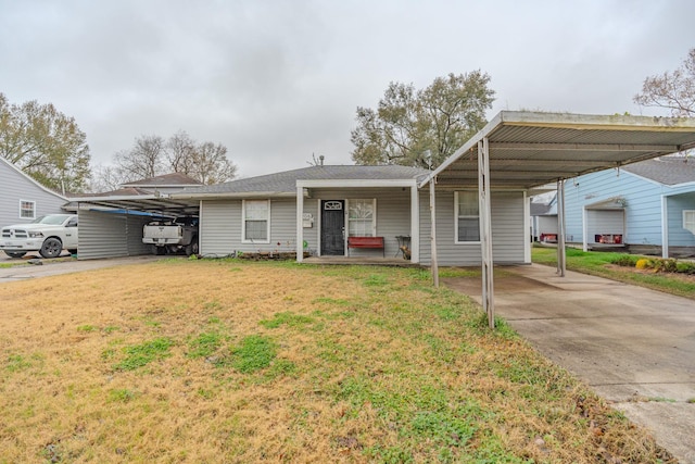 view of front facade with a carport and a front lawn