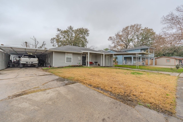 view of front of property with a carport and a front yard