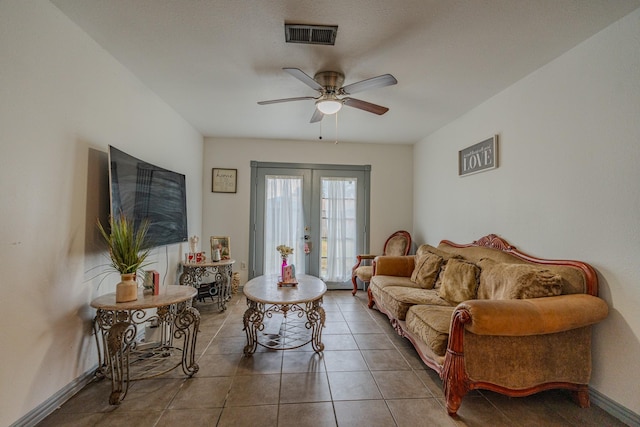 tiled living room featuring french doors and ceiling fan