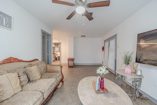 tiled living room featuring ceiling fan