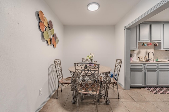 tiled dining space featuring sink