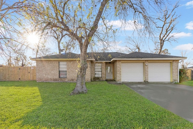 ranch-style home featuring a garage and a front yard