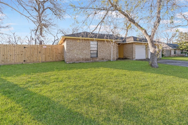 ranch-style home with a garage and a front yard