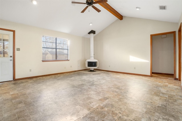 unfurnished living room with ceiling fan, lofted ceiling with beams, and a wood stove