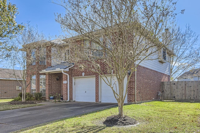 view of front of property featuring a garage and a front lawn