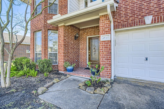 doorway to property with a garage