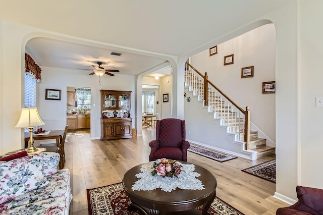 living room with ceiling fan and light wood-type flooring