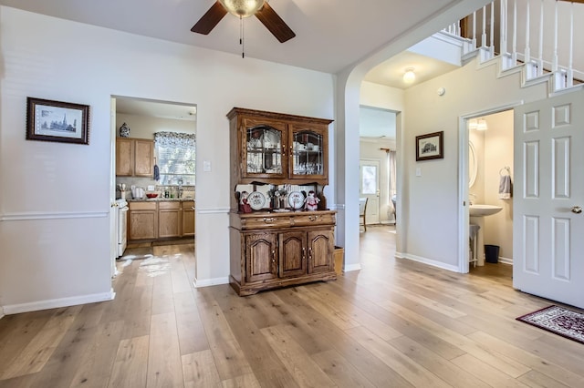 hallway featuring sink and light hardwood / wood-style floors